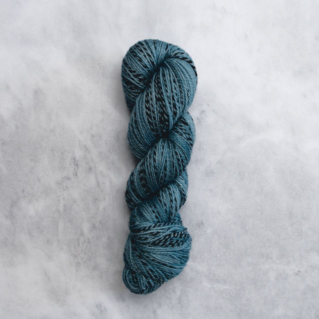 Ocean blue skein of yarn with black stripes.